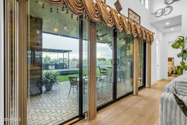 908 W Caldwell St, Phoenix, AZ 85041 - doorway to outside featuring a towering ceiling, visible vents, and wood finished floors