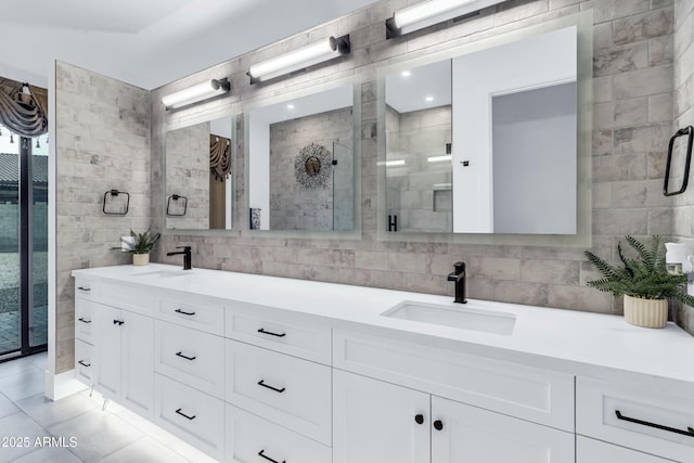 908 W Caldwell St, Phoenix, AZ 85041 - full bath featuring a sink, tile patterned floors, tile walls, and double vanity