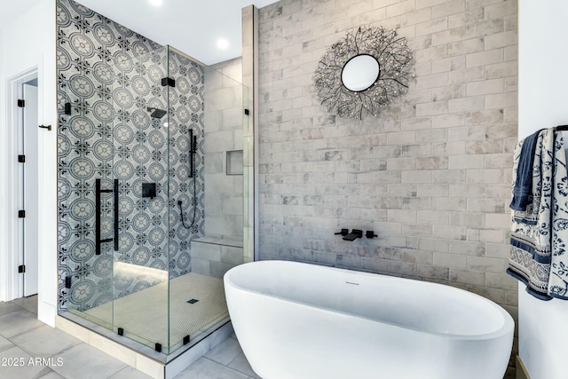 908 W Caldwell St, Phoenix, AZ 85041 - full bathroom with tile walls, tile patterned floors, a freestanding bath, and a stall shower