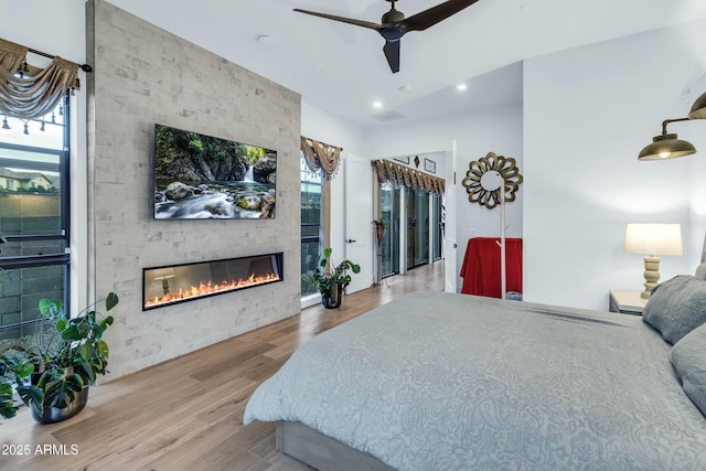 908 W Caldwell St, Phoenix, AZ 85041 - bedroom with ceiling fan, a large fireplace, visible vents, recessed lighting, and wood finished floors