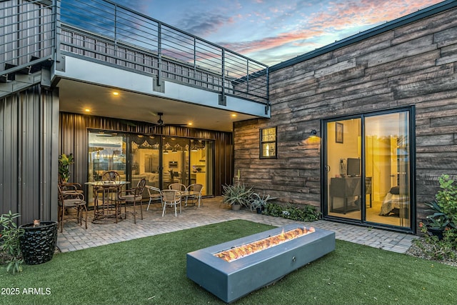 908 W Caldwell St, Phoenix, AZ 85041 - rear view of property featuring a yard, a balcony, an outdoor fire pit, and a patio area