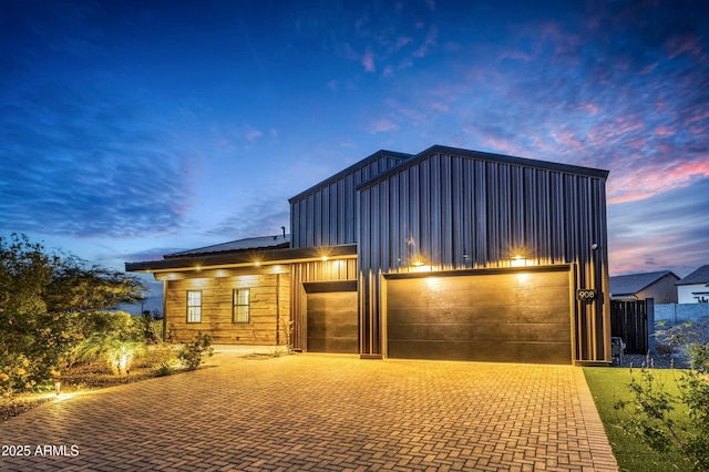 908 W Caldwell St, Phoenix, AZ 85041 - contemporary house with an attached garage, board and batten siding, and decorative driveway