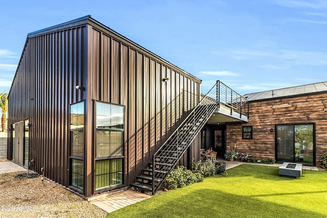 908 W Caldwell St, Phoenix, AZ 85041 - back of property with stairs, metal roof, and a lawn