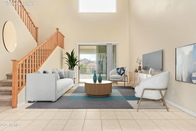 living room with a high ceiling and light tile patterned floors