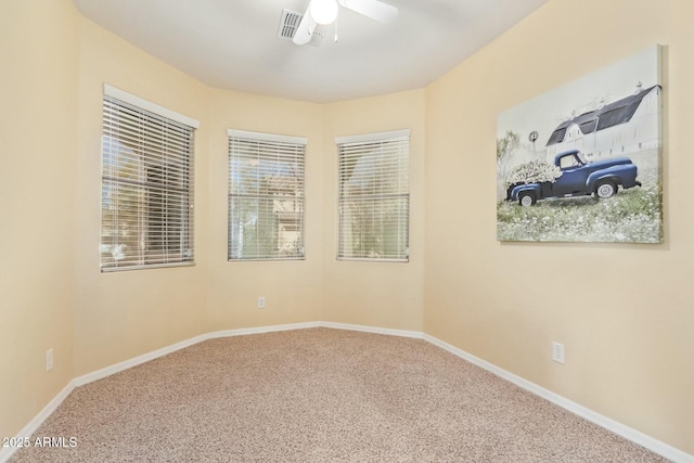 unfurnished room with ceiling fan and carpet flooring