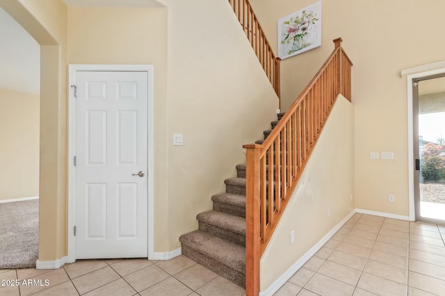 stairs featuring tile patterned flooring