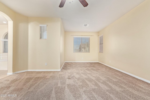 carpeted empty room featuring ceiling fan