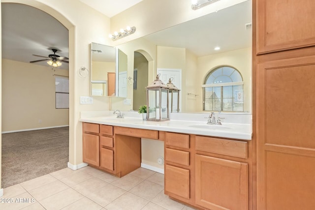 bathroom with tile patterned flooring, vanity, and ceiling fan