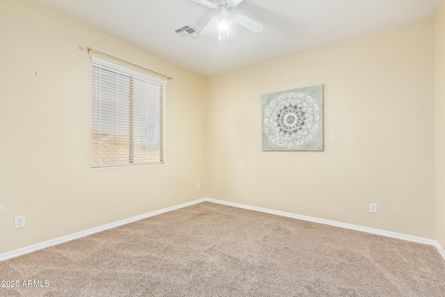 spare room featuring ceiling fan and carpet flooring