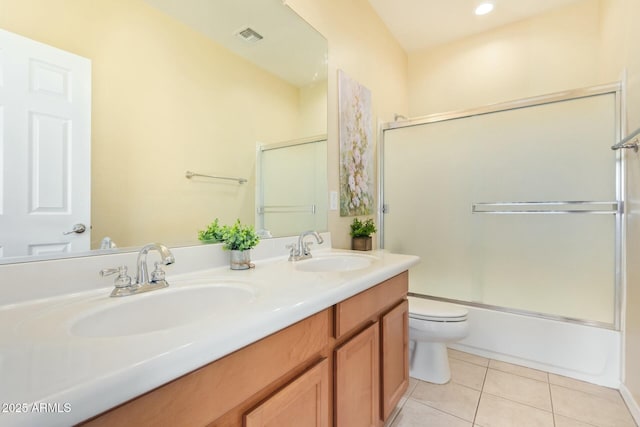 full bathroom with vanity, tile patterned floors, shower / bath combination with glass door, and toilet