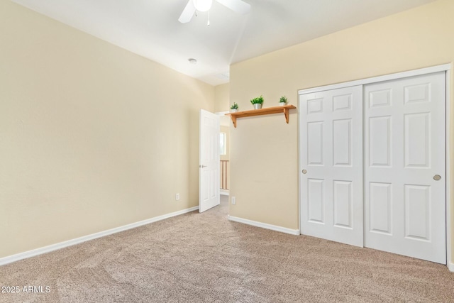 unfurnished bedroom with ceiling fan, a closet, and carpet