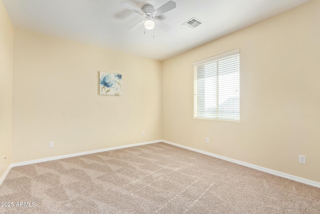 empty room featuring light colored carpet and ceiling fan