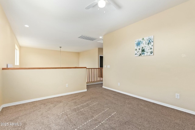 spare room with ceiling fan and carpet floors