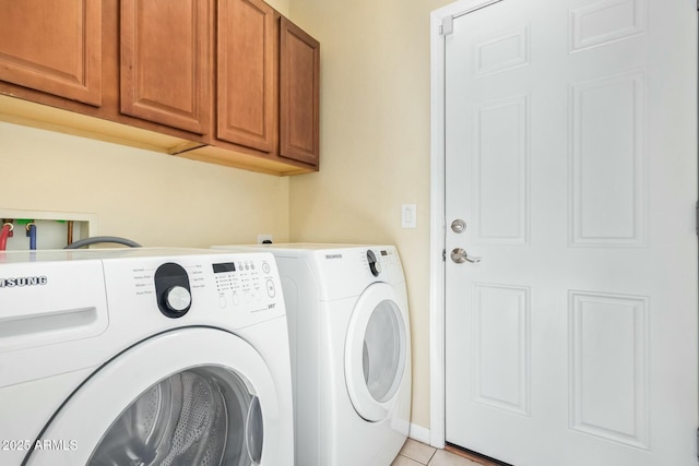 laundry area featuring cabinets, separate washer and dryer, and light tile patterned floors