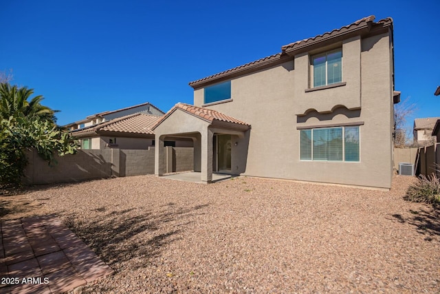 rear view of property featuring a patio area and central air condition unit