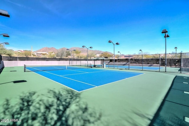 view of tennis court with a mountain view