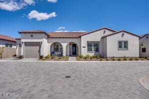 11249 N Blakely St, Surprise, AZ 85388 - mediterranean / spanish house featuring a tiled roof, an attached garage, and stucco siding
