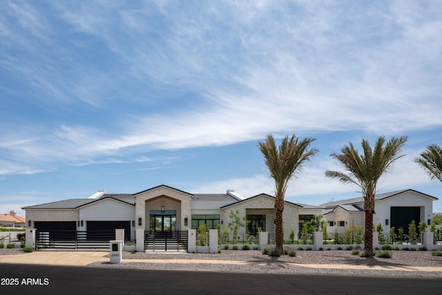 6445 N Cattle Track Rd, Scottsdale, AZ 85250 - view of front facade with a fenced front yard, an attached garage, stucco siding, and stone siding