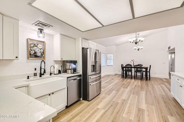 624 N Ashbrook Cir, Mesa, AZ 85213 - kitchen featuring stainless steel appliances, a sink, white cabinets, light countertops, and a chandelier
