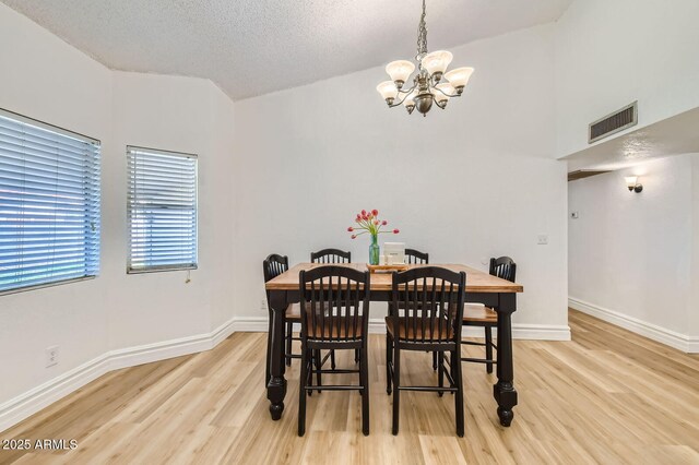 624 N Ashbrook Cir, Mesa, AZ 85213 - dining area featuring a chandelier, light wood-type flooring, baseboards, and a textured ceiling