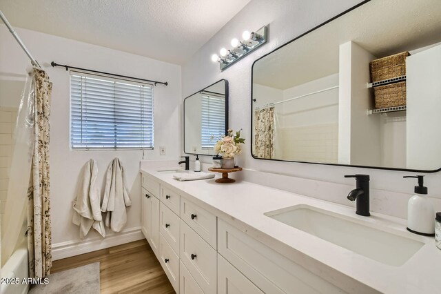 624 N Ashbrook Cir, Mesa, AZ 85213 - full bathroom with double vanity, wood finished floors, a textured ceiling, and shower / bath combination with curtain