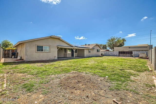 624 N Ashbrook Cir, Mesa, AZ 85213 - rear view of house featuring stucco siding, solar panels, and a patio area