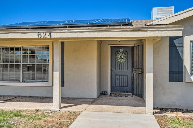 624 N Ashbrook Cir, Mesa, AZ 85213 - view of exterior entry with stucco siding and roof mounted solar panels