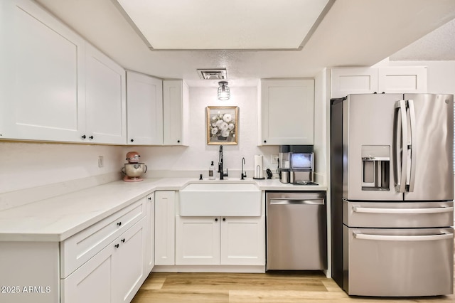 624 N Ashbrook Cir, Mesa, AZ 85213 - kitchen with appliances with stainless steel finishes, a sink, white cabinets, and light wood-style floors