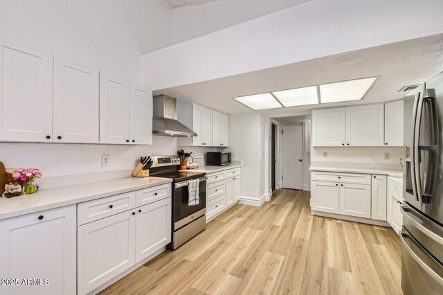 624 N Ashbrook Cir, Mesa, AZ 85213 - kitchen featuring wall chimney exhaust hood, appliances with stainless steel finishes, white cabinets, light wood-type flooring, and light countertops