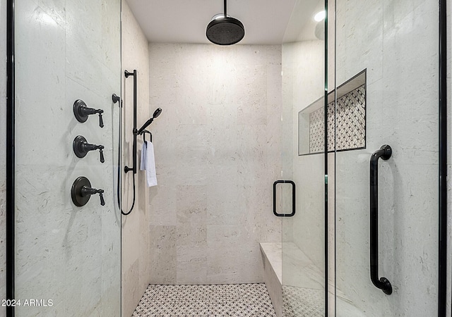 bathroom with a shower with door