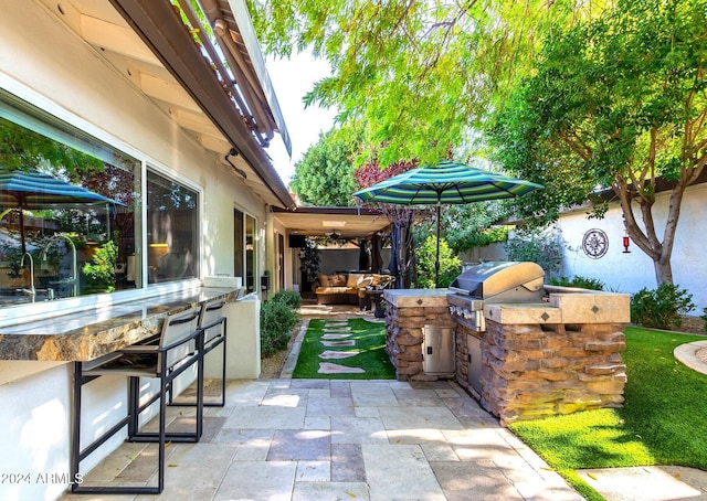 view of patio with area for grilling and grilling area