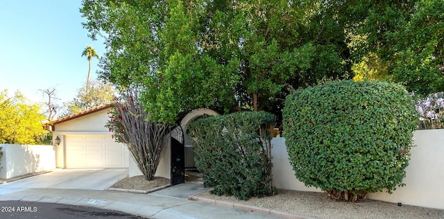 obstructed view of property with a garage