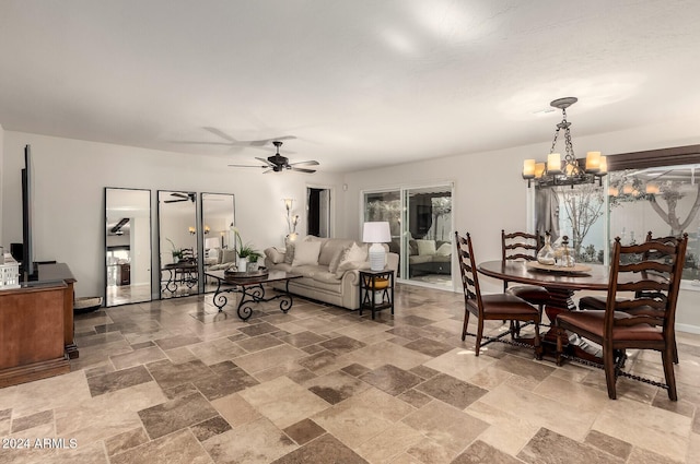 living room featuring ceiling fan with notable chandelier