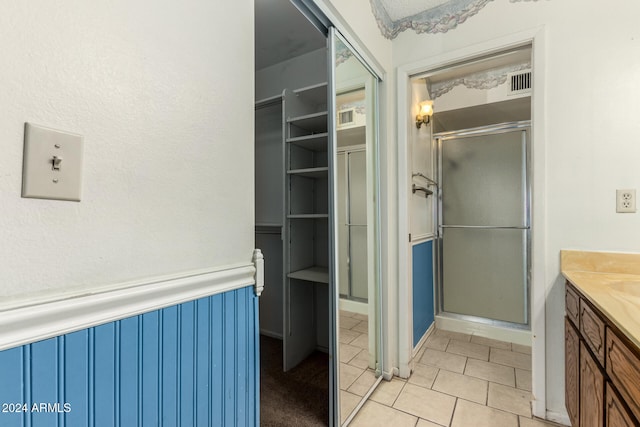 bathroom with vanity and a shower with shower door