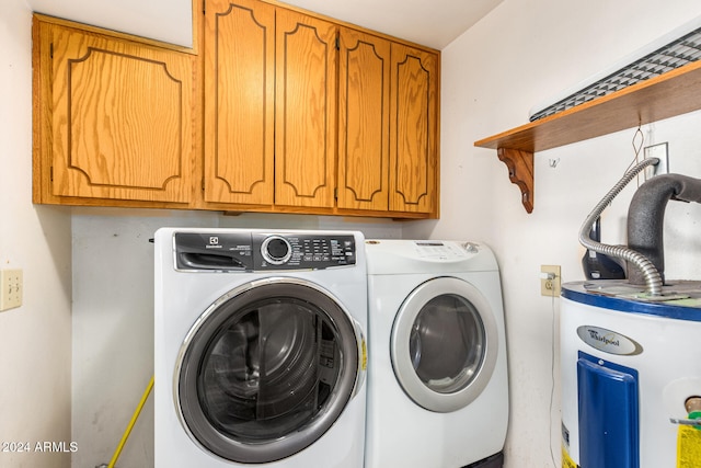 laundry area with separate washer and dryer, water heater, and cabinets