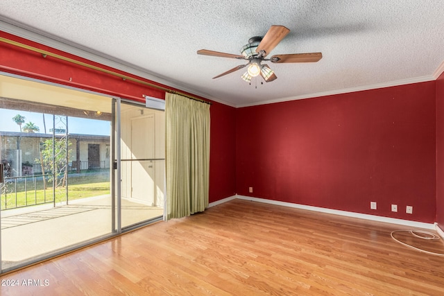 empty room featuring ceiling fan, wood-type flooring, and a textured ceiling