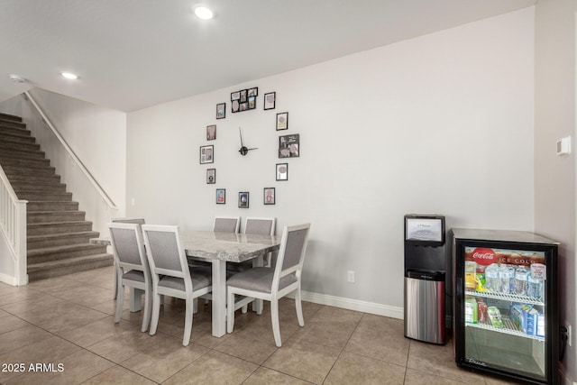tiled dining room featuring stairs, baseboards, recessed lighting, and wine cooler