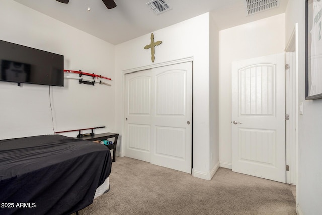 carpeted bedroom featuring a closet, baseboards, and ceiling fan