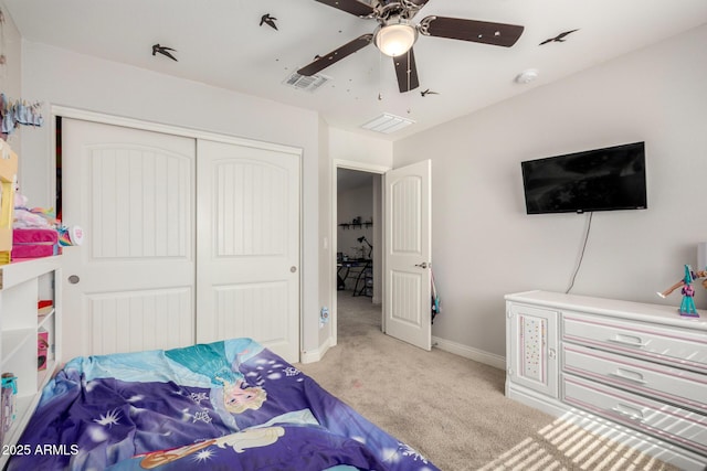 carpeted bedroom with a closet, baseboards, and a ceiling fan