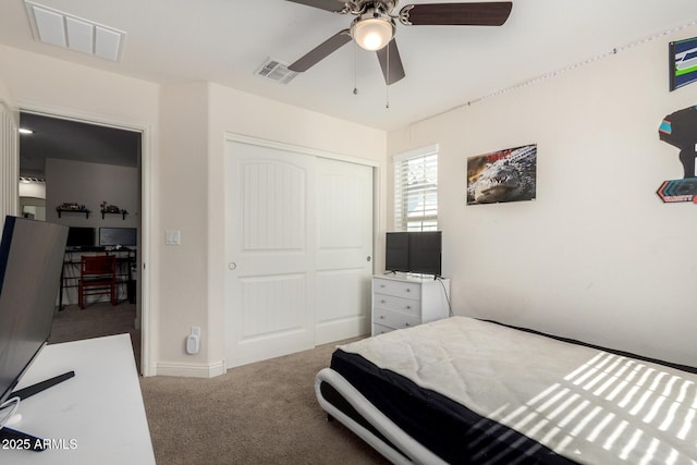 carpeted bedroom with a closet, ceiling fan, and baseboards