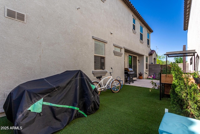 rear view of property featuring a patio area and stucco siding