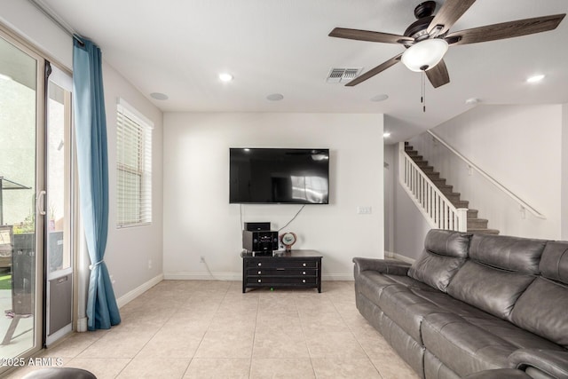 living area with ceiling fan, stairs, baseboards, recessed lighting, and light tile patterned floors
