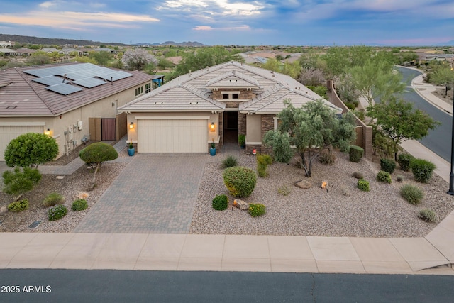 31207 N 124th Dr, Peoria, AZ 85383 - view of front of home featuring an attached garage, decorative driveway, stucco siding, a tile roof, and fence