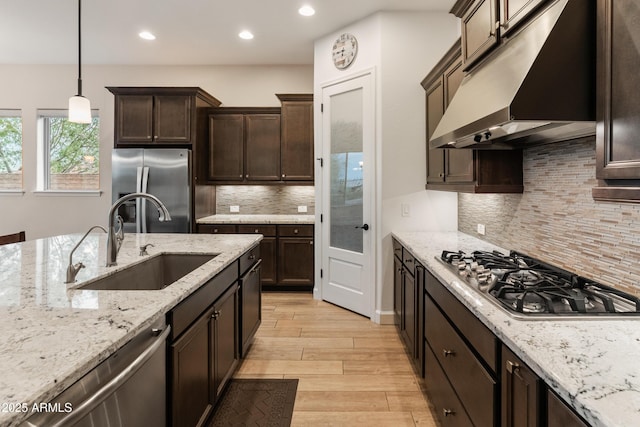 31207 N 124th Dr, Peoria, AZ 85383 - kitchen featuring under cabinet range hood, appliances with stainless steel finishes, a sink, recessed lighting, and dark brown cabinetry