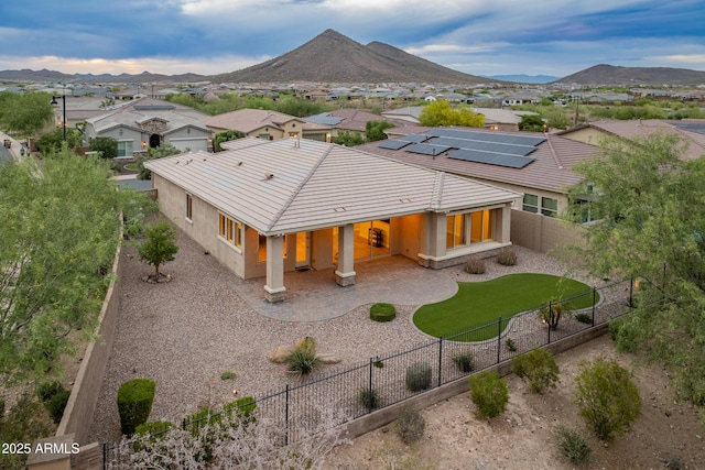 31207 N 124th Dr, Peoria, AZ 85383 - back of house with stucco siding, a fenced backyard, a residential view, and a mountain view