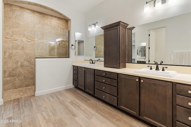31207 N 124th Dr, Peoria, AZ 85383 - bathroom featuring wood finished floors, a walk in shower, double vanity, and baseboards