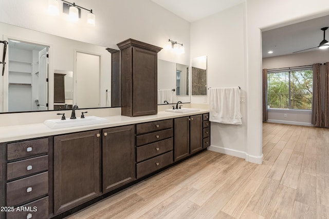 31207 N 124th Dr, Peoria, AZ 85383 - full bathroom with double vanity, wood finished floors, and baseboards