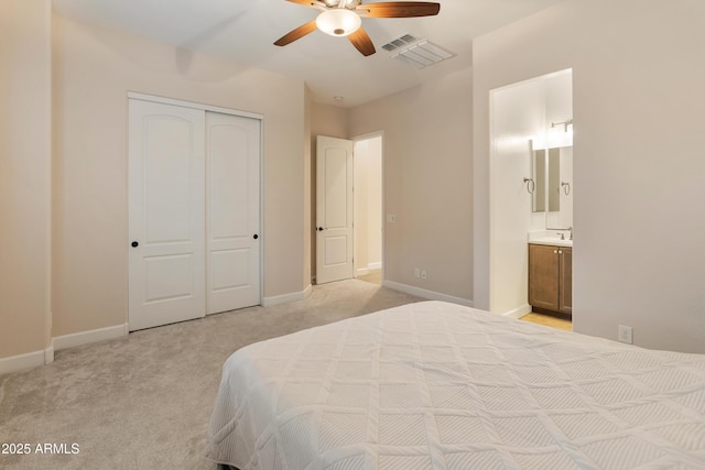 31207 N 124th Dr, Peoria, AZ 85383 - bedroom with light colored carpet, a closet, ensuite bath, and baseboards
