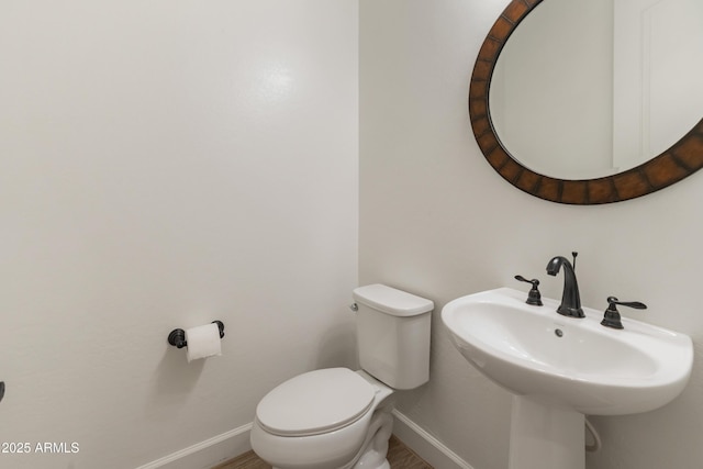 31207 N 124th Dr, Peoria, AZ 85383 - half bathroom featuring baseboards, toilet, and a sink