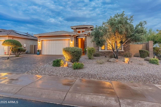 31207 N 124th Dr, Peoria, AZ 85383 - prairie-style house featuring driveway, an attached garage, stucco siding, stone siding, and fence